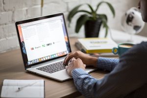 man checking emails on laptop