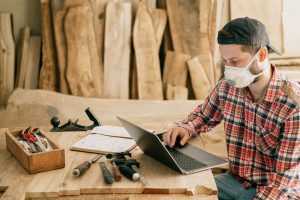 construction worker with laptop in work station
