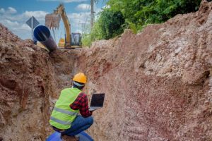 construction worker with laptop in site